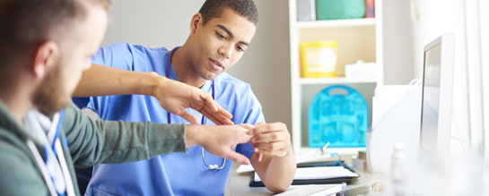 doctor examining hand