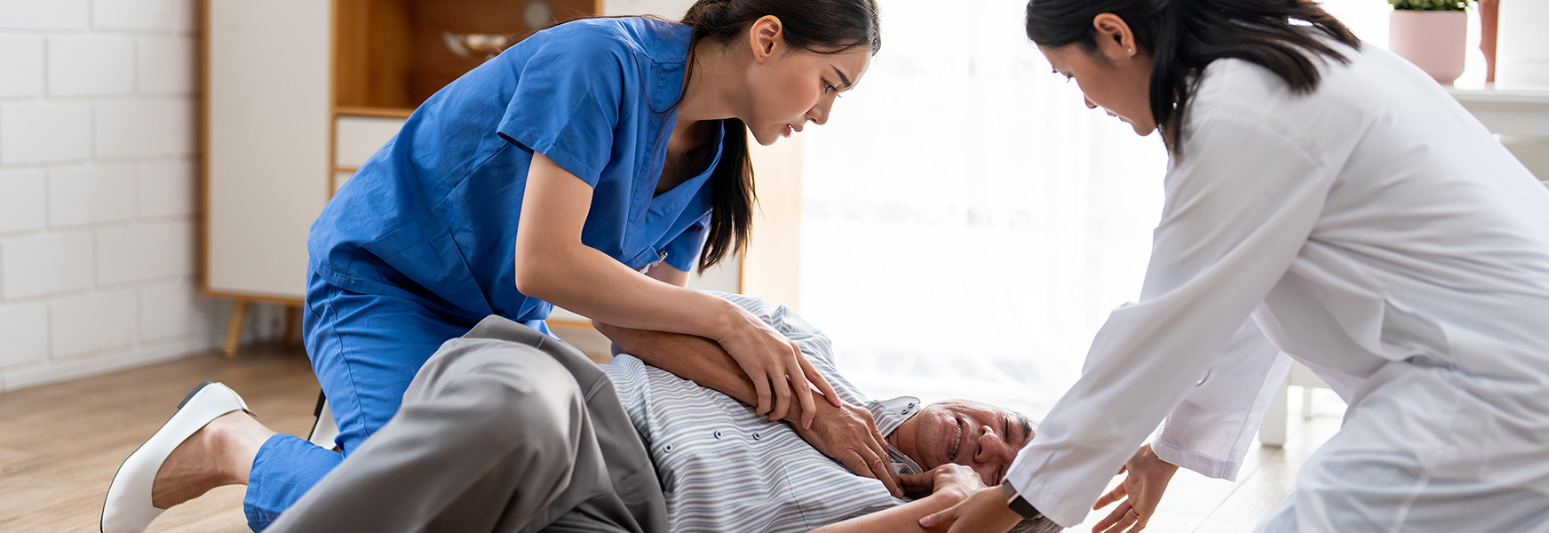 Healthcare workers assisting fallen patient