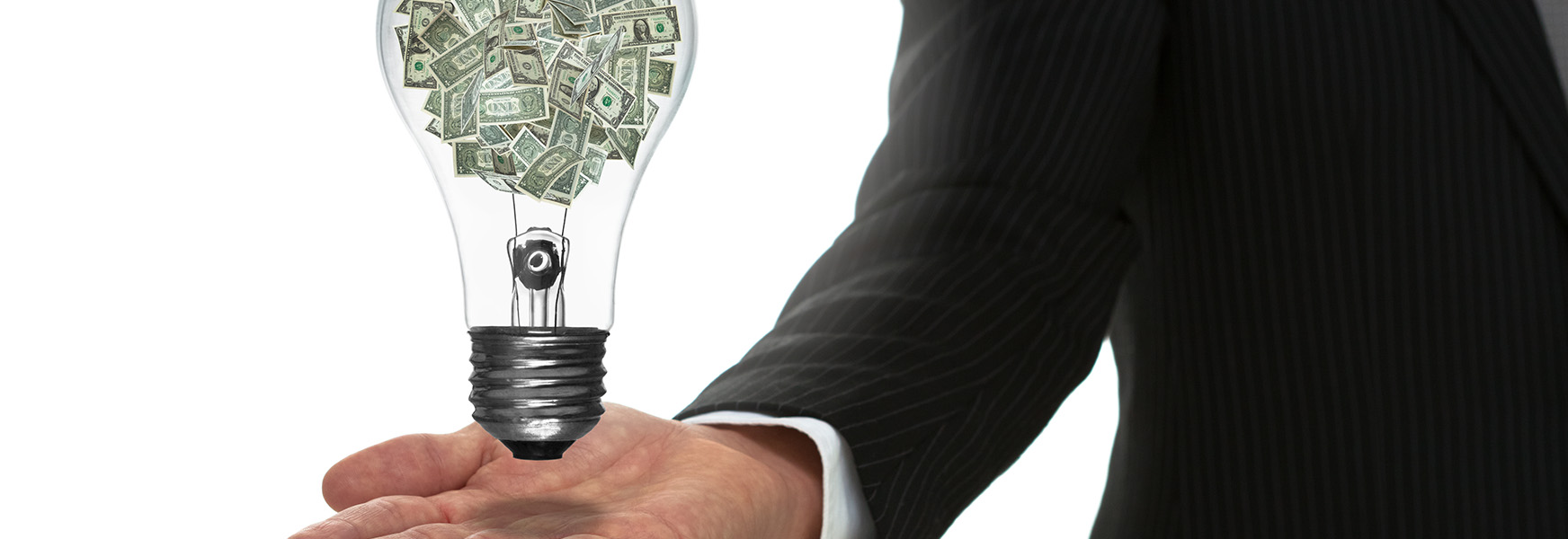 close-up man in suit holding light bulb with dollar bills in it
