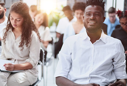 Multicultural audience in a modern conference room