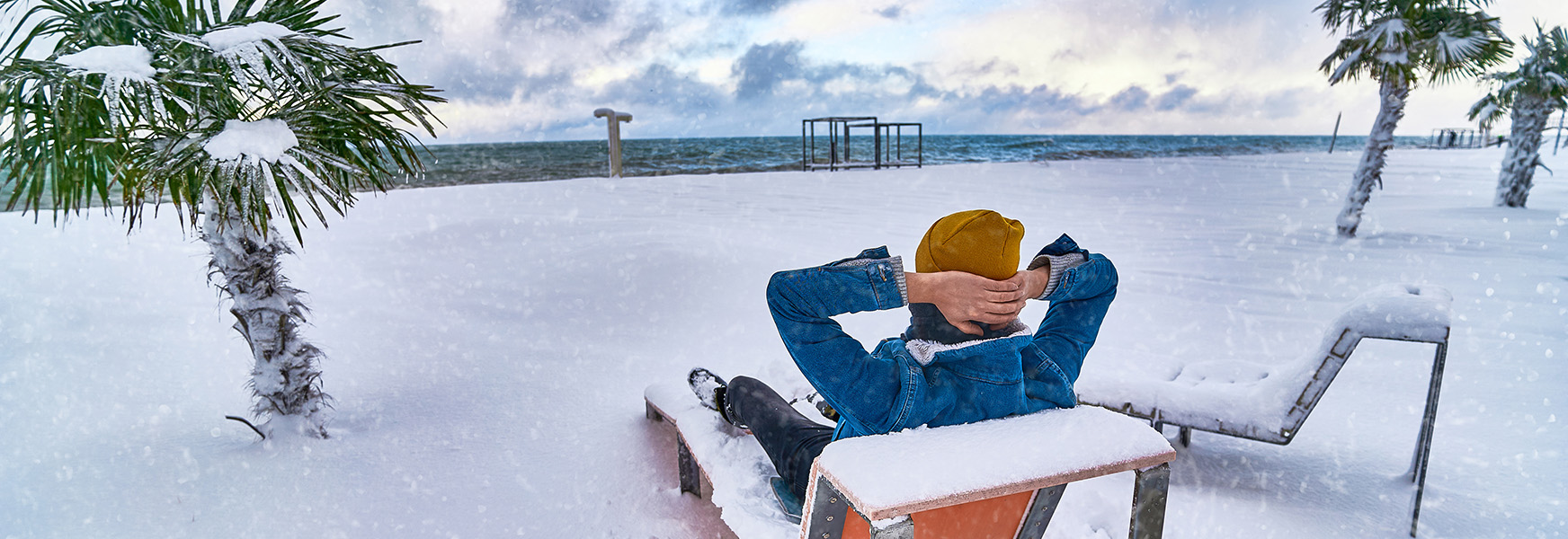 Person resting on a snowy tropical beach