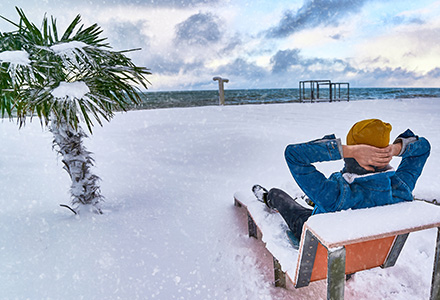 Person resting on a snowy tropical beach