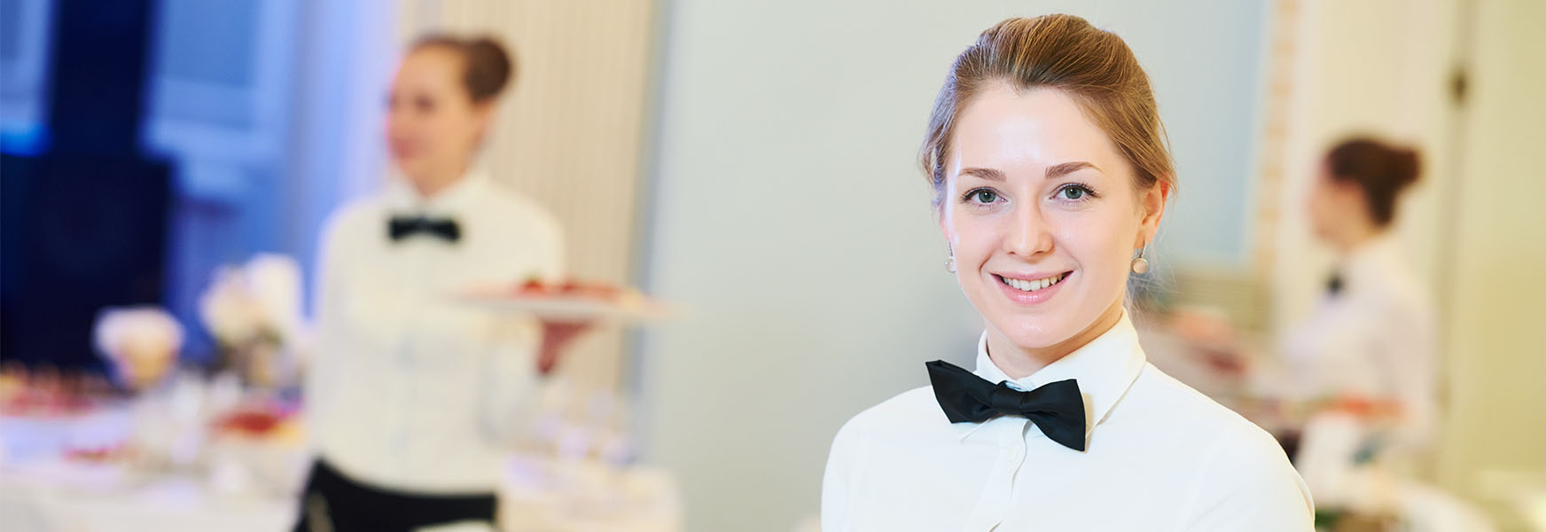 Hospitality staff serving food during hotel event function