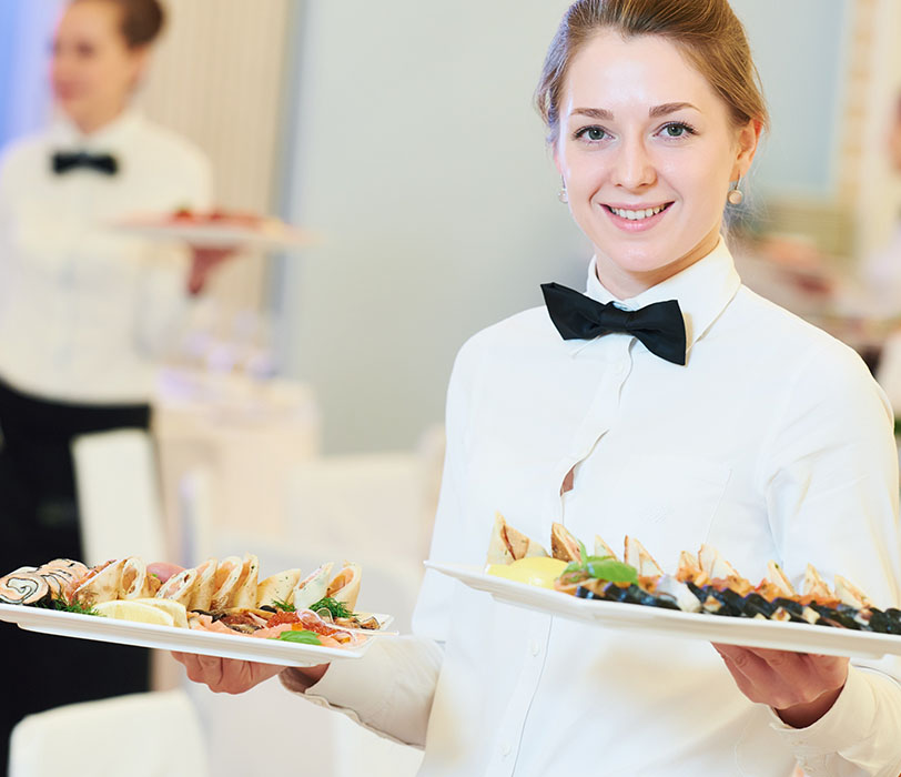 Hospitality staff serving food during hotel event function
