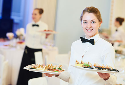 Hospitality staff serving food during hotel event function