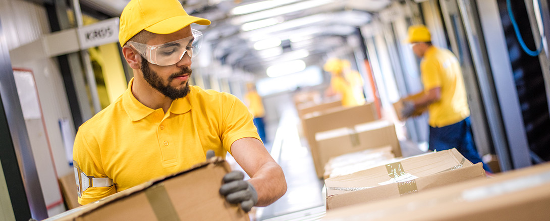 worker in safety glasses working at warehouse distribution facility