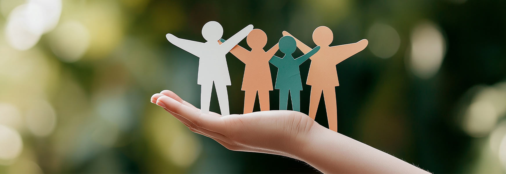 Hands holding paper people figures